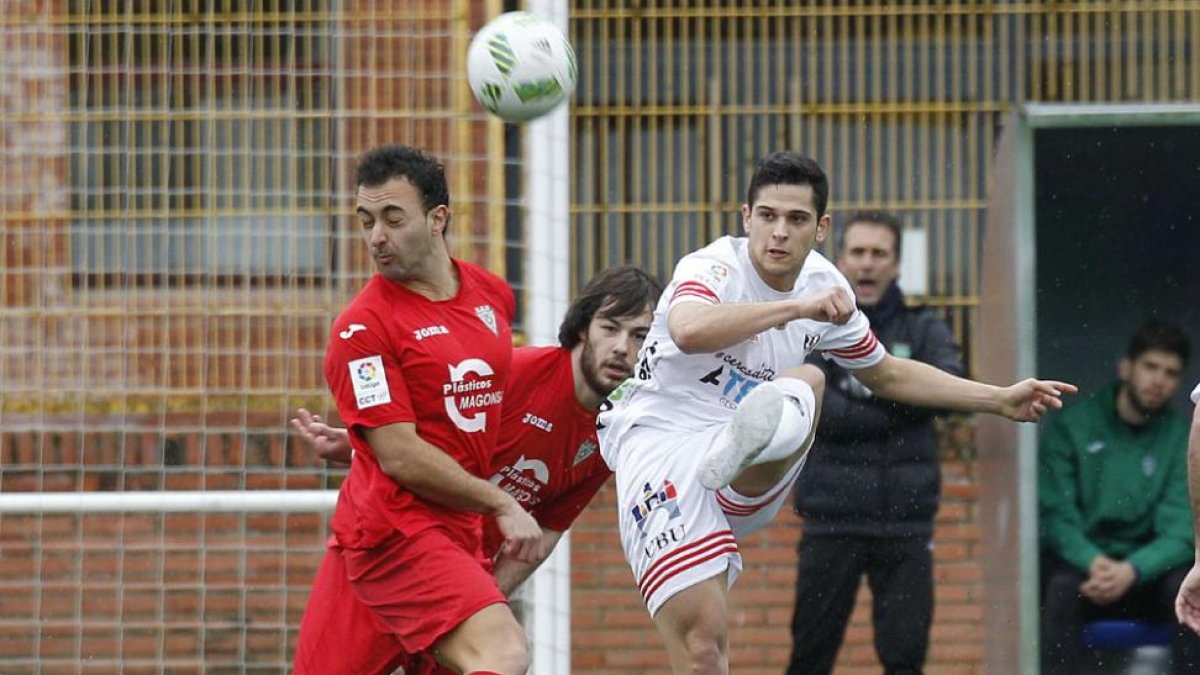 Marcos despeja un balón ante la presión de dos jugadores del Villamuriel en el choque de ayer en San Amaro-Santi Otero