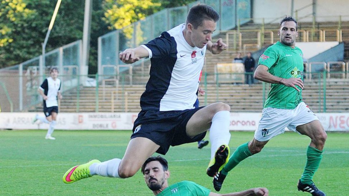 Sergio Cortés, que saltó al césped en la segunda mitad, salta para salvar la entrada de un jugador del Guijuelo-I. L. Murillo