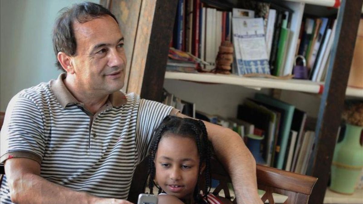 El alcalde de Lucano, Domenico Lucano, con una niña originaria de Etiopía.-MARIO LAPORTA (AFP)