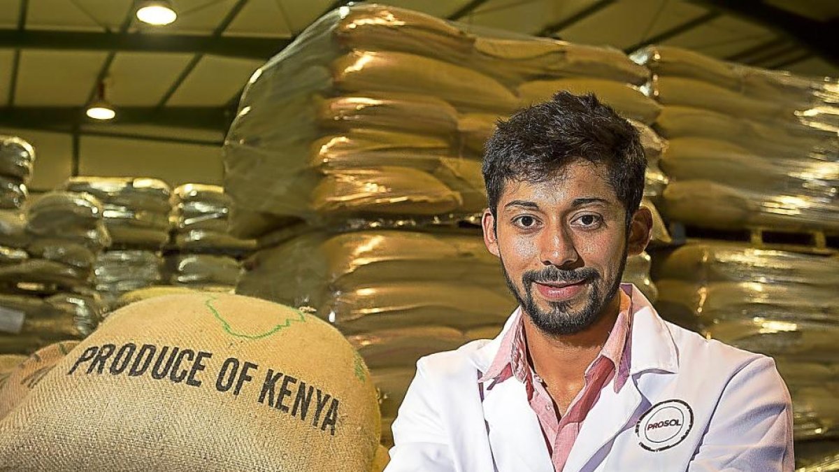 Grabiel Céspedes muestras en sus manos los granos de café en la fábrica palentina de Prosol.-MIGUEL Á. SANTOS