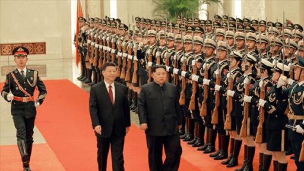 Kim Jong-un y Xi Jinping pasan revista a la guardia de honor en Pekín, en una imagen de archivo.-REUTERS / KCNA