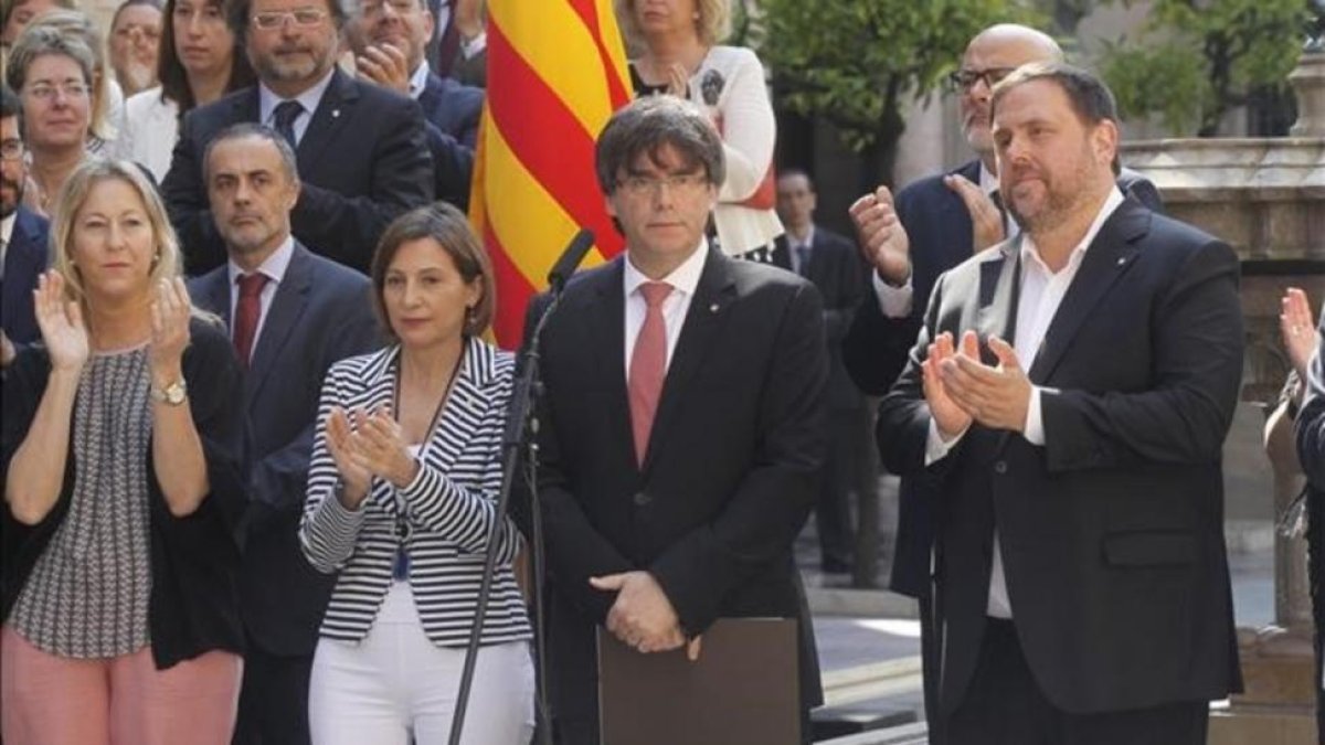 El 'president', Carles Puigdemont, y el vicepresidente del Govern, Oriol Junqueras, durante el anuncio de la fecha y la pregunta del referéndum.-JULIO CARBÓ