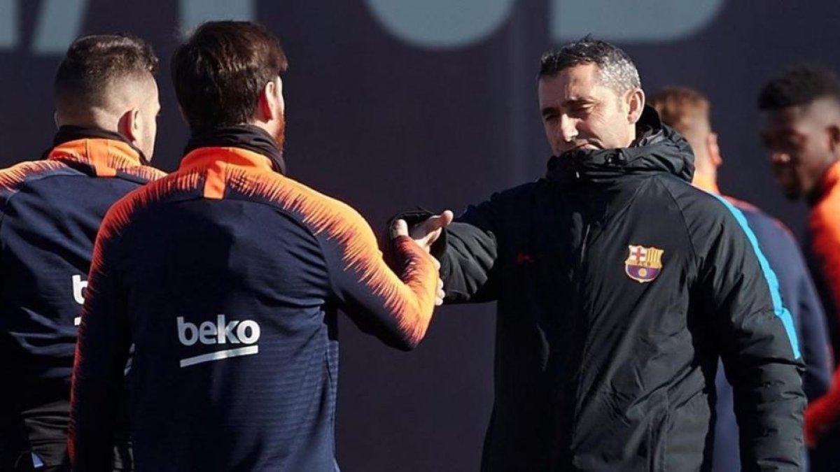 Messi y Valverde se saludan en el inicio del entrenamiento.-ALEJANDRO GARCÍA