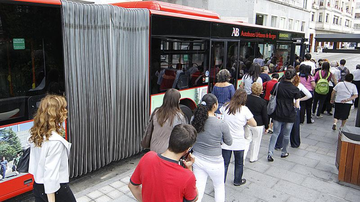 Varias personas esperan para subir al autobús.-RAÚL G. OCHOA