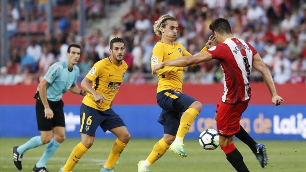 Griezmann y Espinosa disputan el balón durante el partido jugado en Montilivi-PAU BARRENA