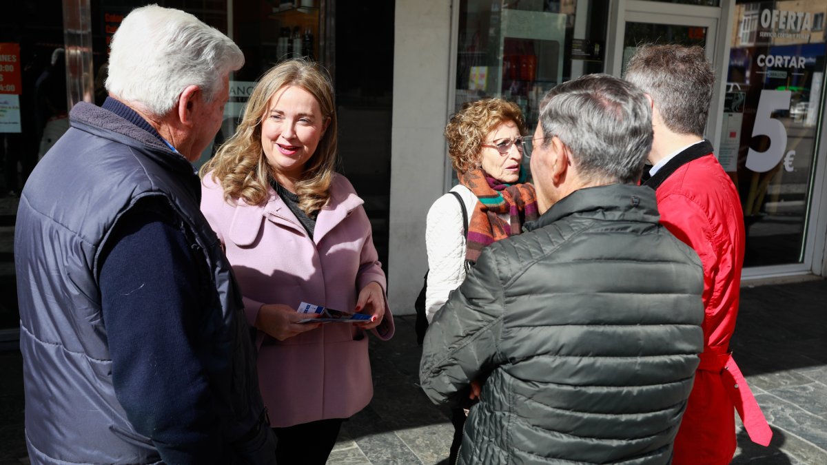 Cristina Ayala, candidata del PP a la Alcaldía de Burgos, charla con unos vecinos en la plaza de Santiago de Gamonal. TOMÁS ALONSO