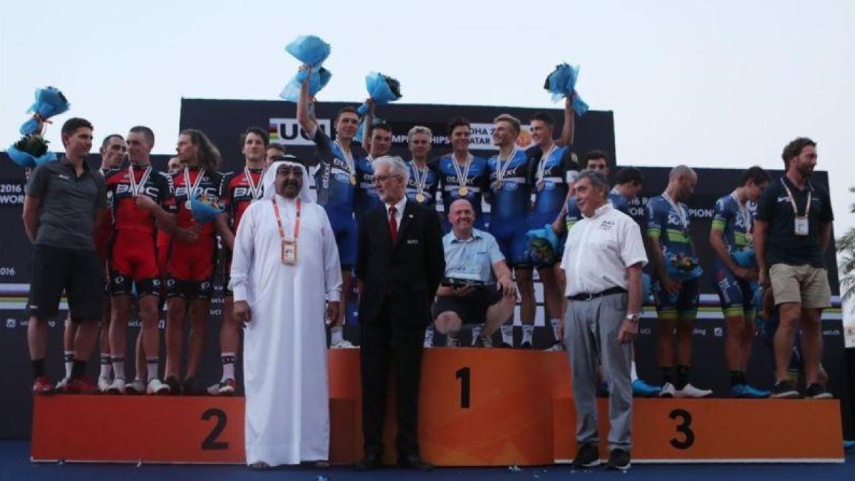 El equipo Etixx QuickStep (centro), flanqueado por el BMC (izquierda) y el Orica en el podio de la contrarreloj por equipos del Mundial.-AFP / KARIM JAAFAR