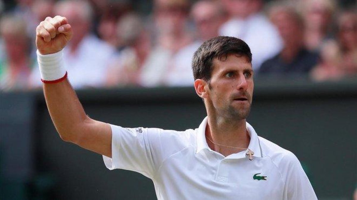 Djokovic celebra un punto ante Federer en la final de Wimbledon.-