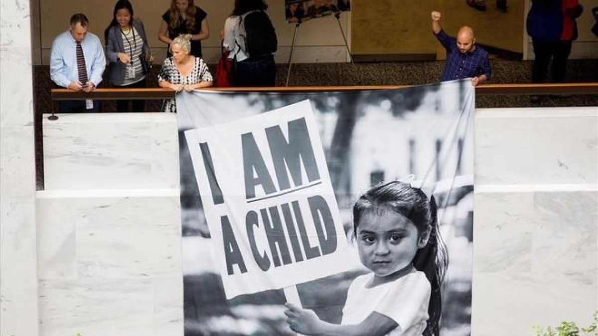 Participantes en una protesta para demandar a Trump la reunificación de las familias de inmigrantes separadas en la frontera, este jueves, en Washington.-MICHAEL REYNOLDS (EFE)