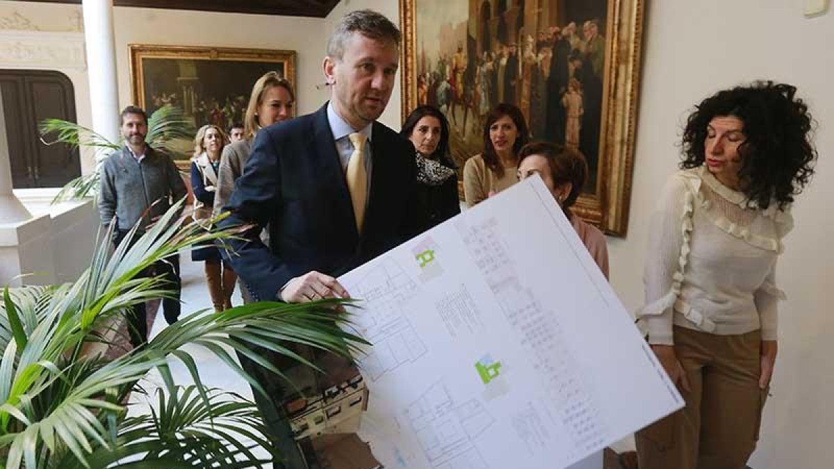 El alcalde porta el proyecto ganador, acompañado por miembros del jurado.-RAÚL G. OCHOA