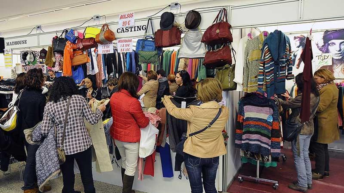 Varias personas miran prendas en la feria del año pasado.-ISRAEL L. MURILLO