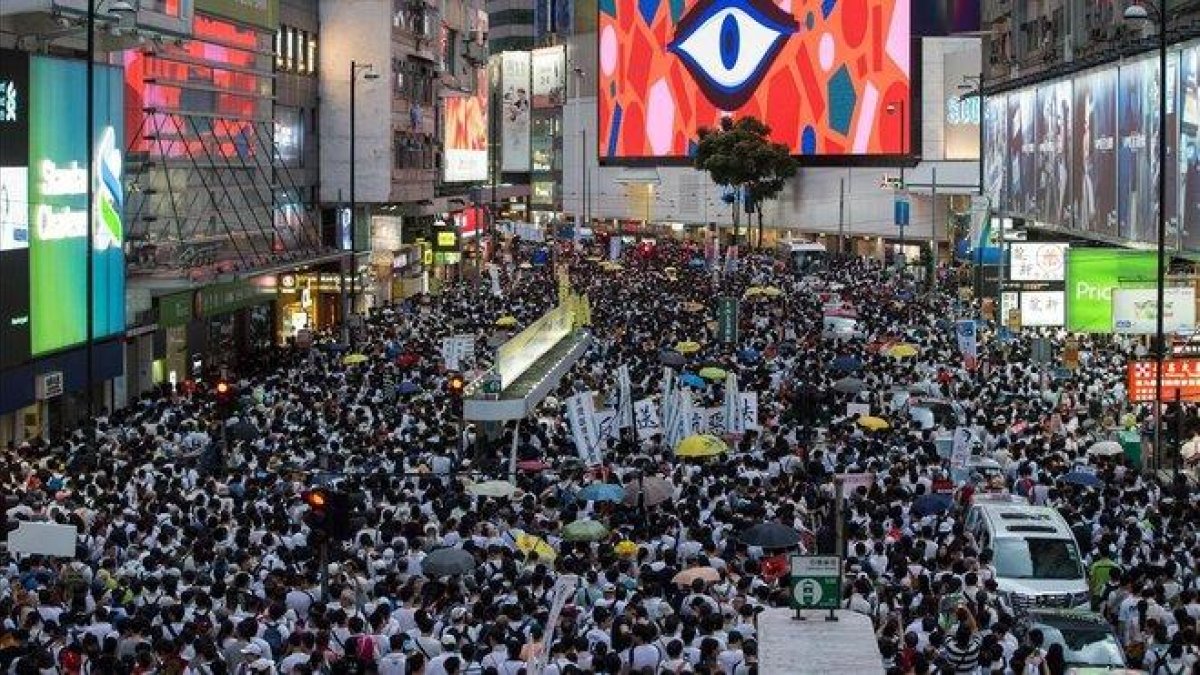 Imagen de la multitudinaria manifestación que ha recorrido las calles de Hong Kong, este sábado.-EFE / JEROME FAVRE