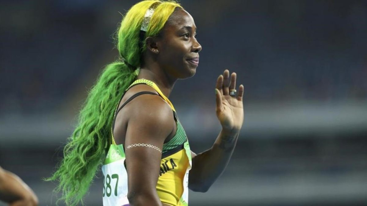 Fraser-Pryce, con los colores de la bandera jamaicana en el pelo.-REUTERS / LUCY NICHOLSON