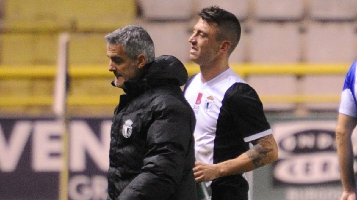 Jonatan Valle sale del campo junto a Joaquín Sáez, masajista del equipo.-ISRAEL L. MURILLO