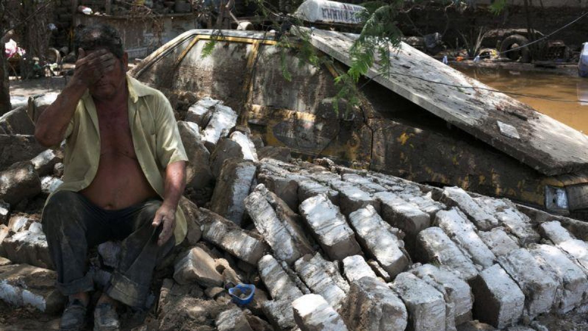 Un hombre, junto a los restos de su casa, arrasada por las inundaciones en Trujillo (Perú).-STRINGER / REUTERS