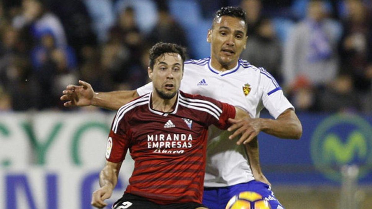 Pedro Martín protege el balón ante la presión del central zaragocista Cabrera.-LFP