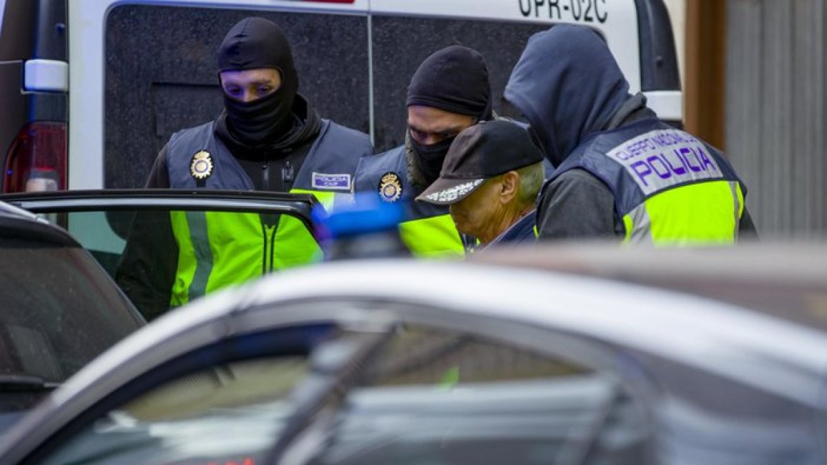 El jubilado de Miranda de Ebro es conducido por la Policía al interior de un coche policial. ICAL