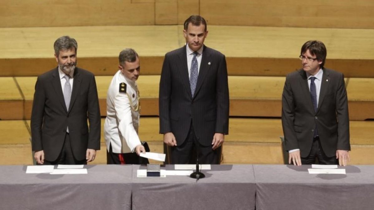 El rey Felipe VI preside junto al 'president' Carles Puigdemont la entrega de despachos de la nueva promoción de jueces, en Barcelona.-ALBERT BERTRAN