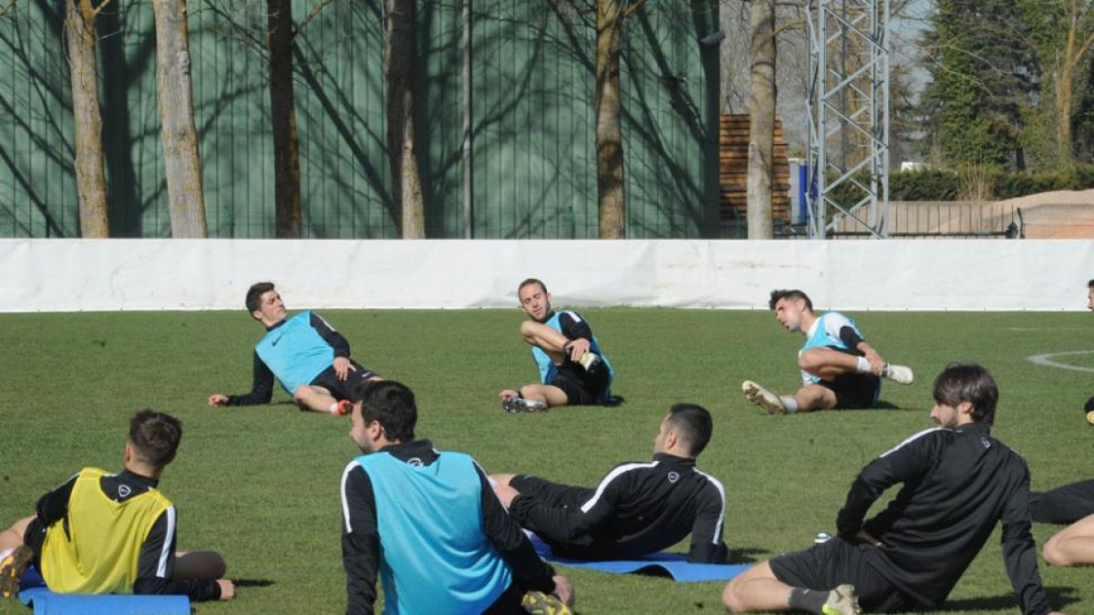 Varios jugadores del Burgos CF hacen estiramientos durante una sesión de trabajo en Castañares-I. L. Murillo