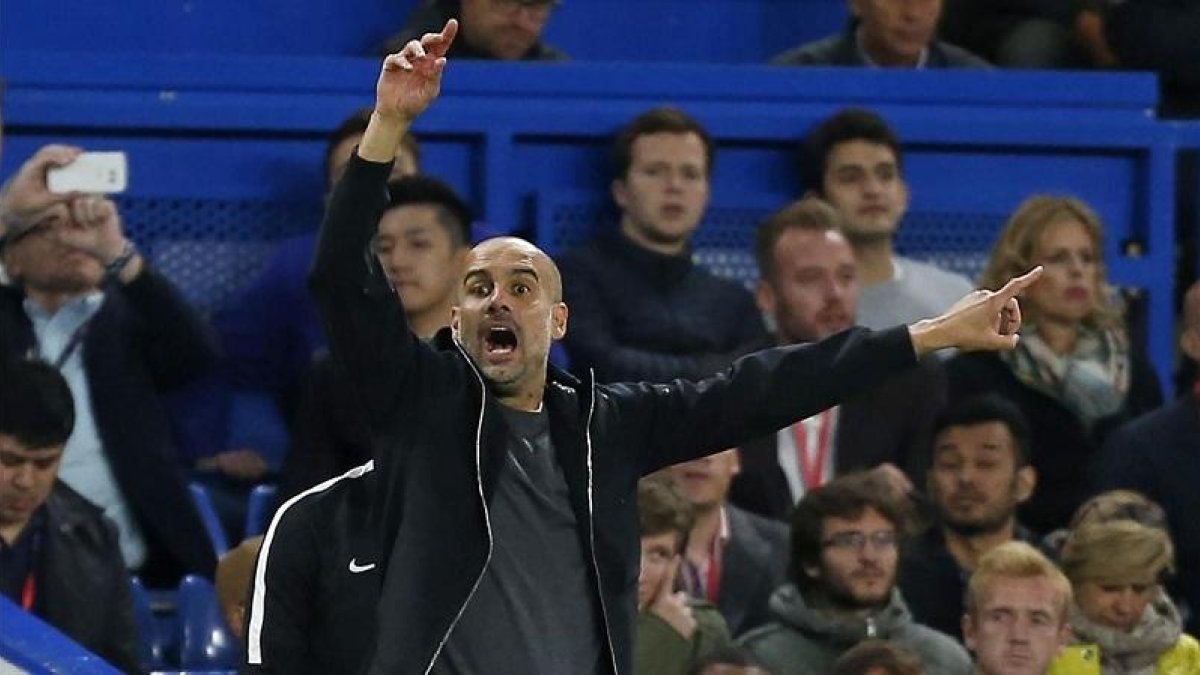 Guardiola da instrucciones a los jugadores del City en Stamford Bridge.-AFP / IAN KINGTON