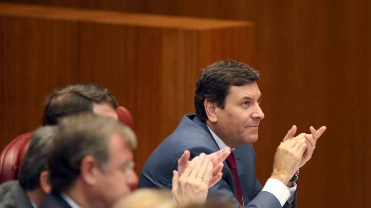 El portavoz interino del Grupo Parlamentario Popular, Carlos Fernández Carriedo, aplaude la intervención del candidato del PP a la Presidencia de la Junta, Juan Vicente Herrera-Ical