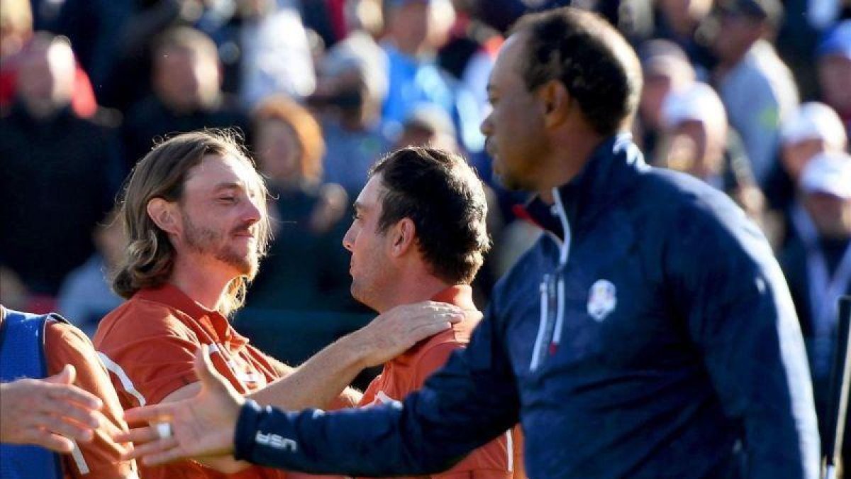 Fletwood y Molinari se felicitan tras sumar un nuevo punto en presencia de Woods-EFE / GERRY PENNY