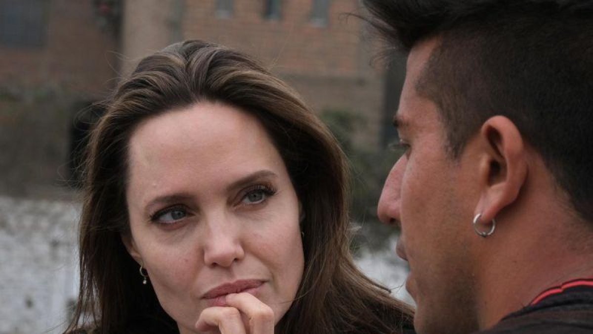 Angelina Jolie conversa con un joven bailarin venezolano en Lima, Peru.-EFE / ACNUR