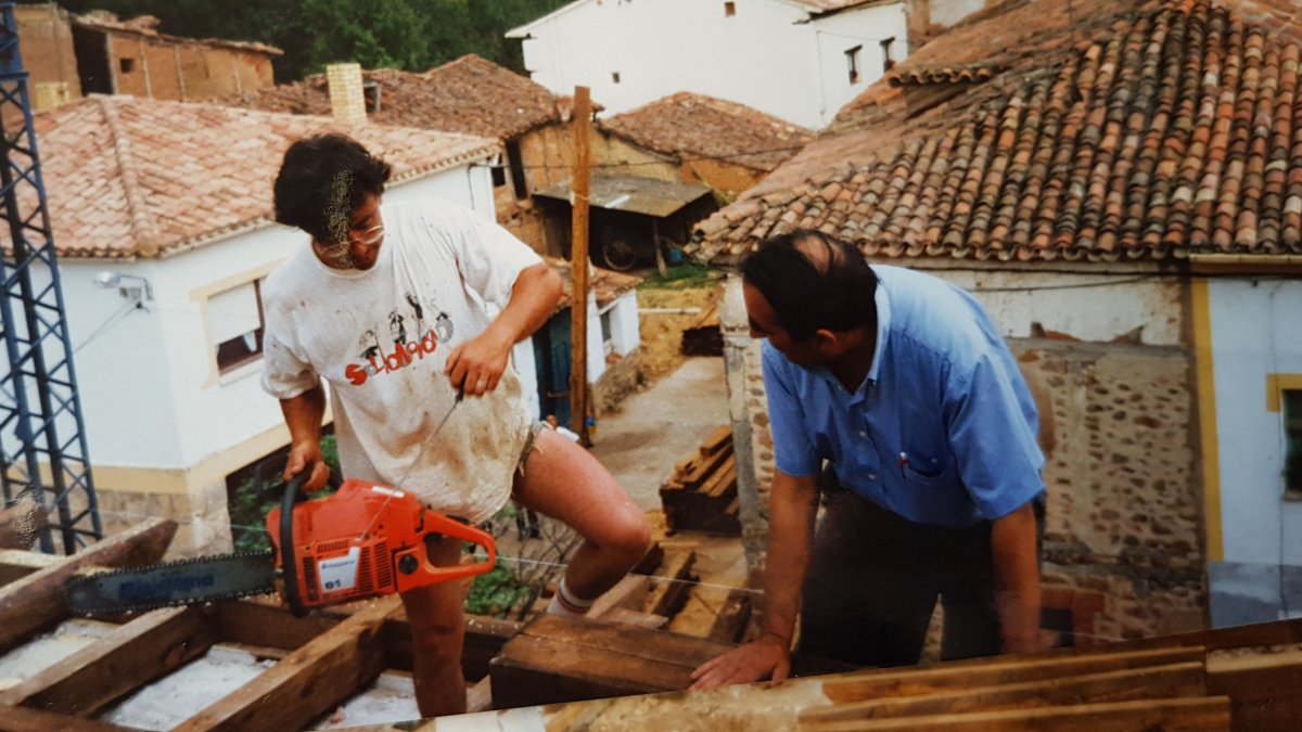 Fermín, con camiseta blanca, en una foto de su archivo arreglando el tejado de la iglesia de Puentedura. F.G.