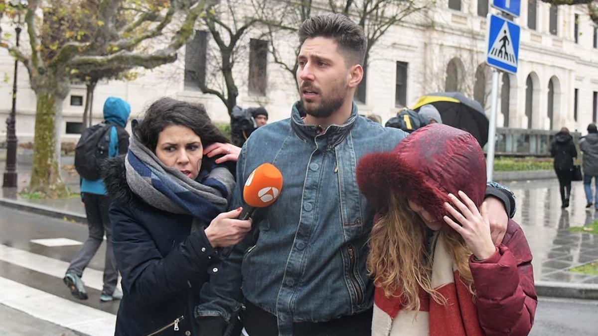 Víctor Rodríguez se aleja del Palacio de Justicia junto a su novia perseguido por una redactora de televisión.-ICAL