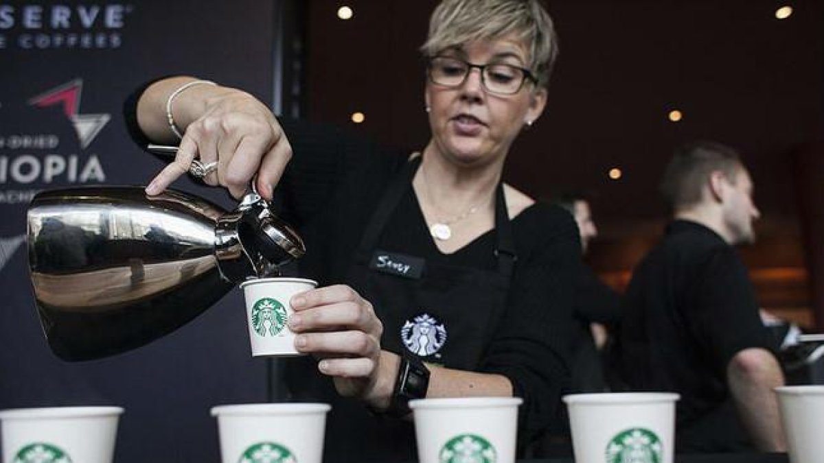 Una camarera de Starbucks sirve cafés durante un encuentro de accionistas de la compañía, el pasado marzo en Seattle.-REUTERS / DAVID RYDER