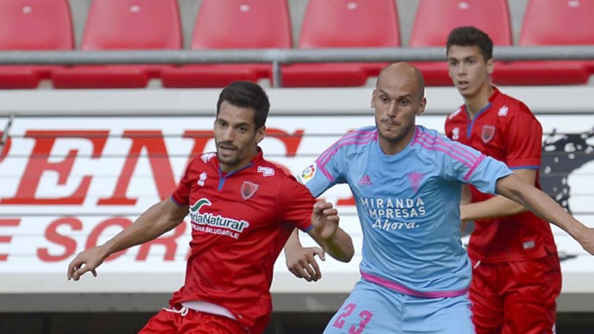 Javi Hervás pugna por un balón con un centrocampista del Numancia en el duelo de ayer en Los Pajaritos-LALIGA.ES
