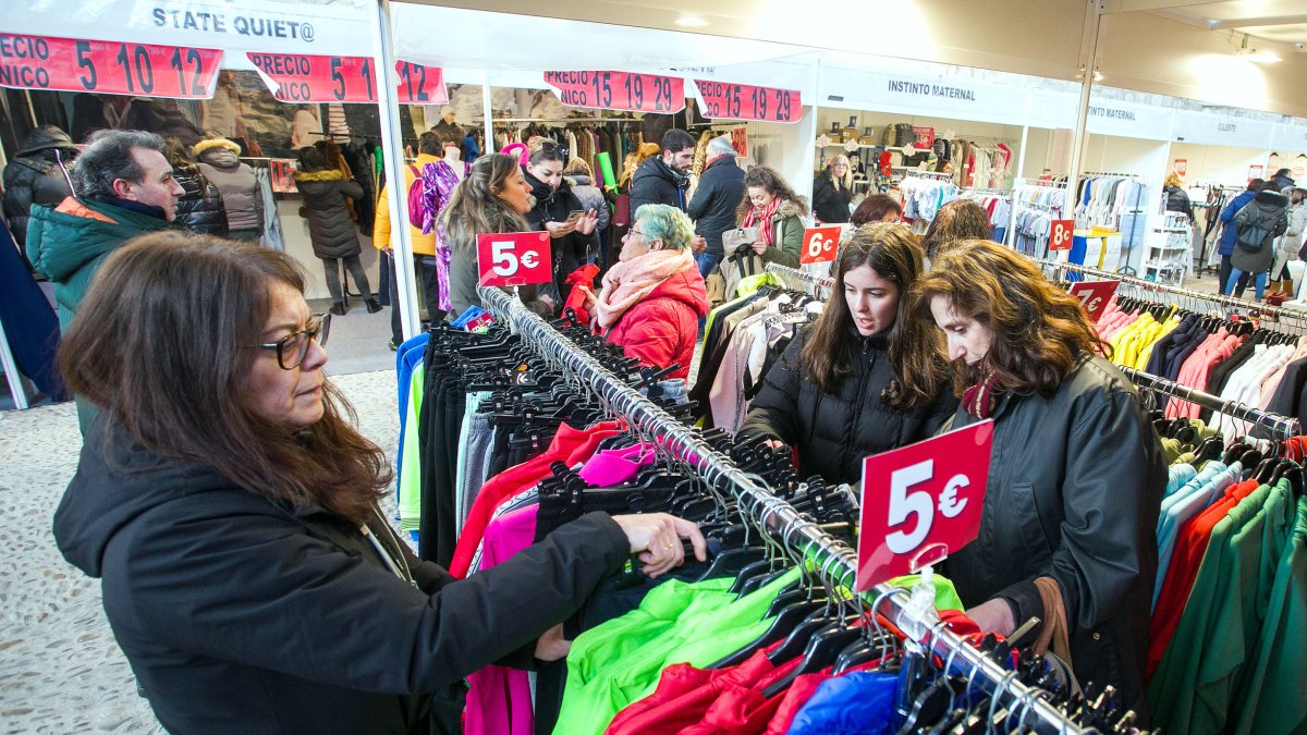 Una mujer busca prendas en la feria de stock. TOMÁS ALONSO