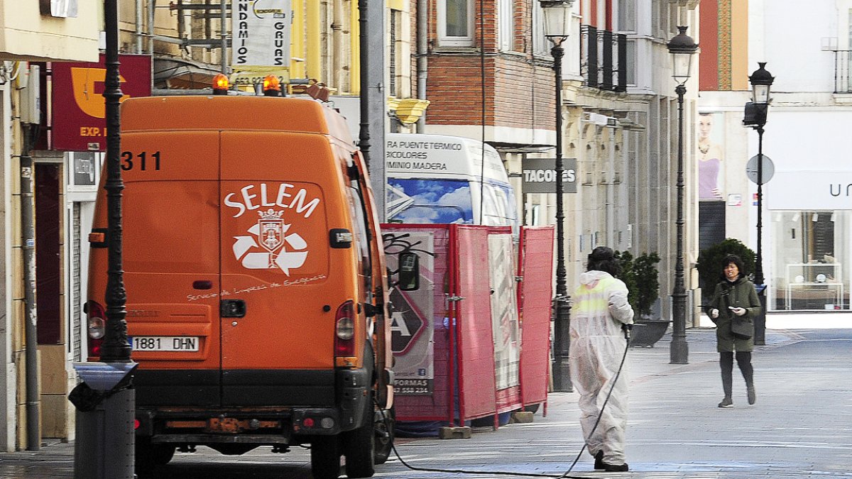 Una operaria trabaja con la manguera desinfectando la calle San Juan.ISRAEL L. MURILLO