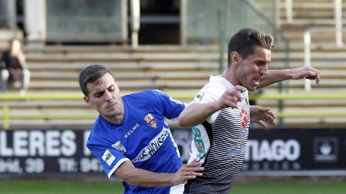 Adrián Cruz intenta salvar la entrada de un jugador del Logroñés, ayer.-SANTI OTERO