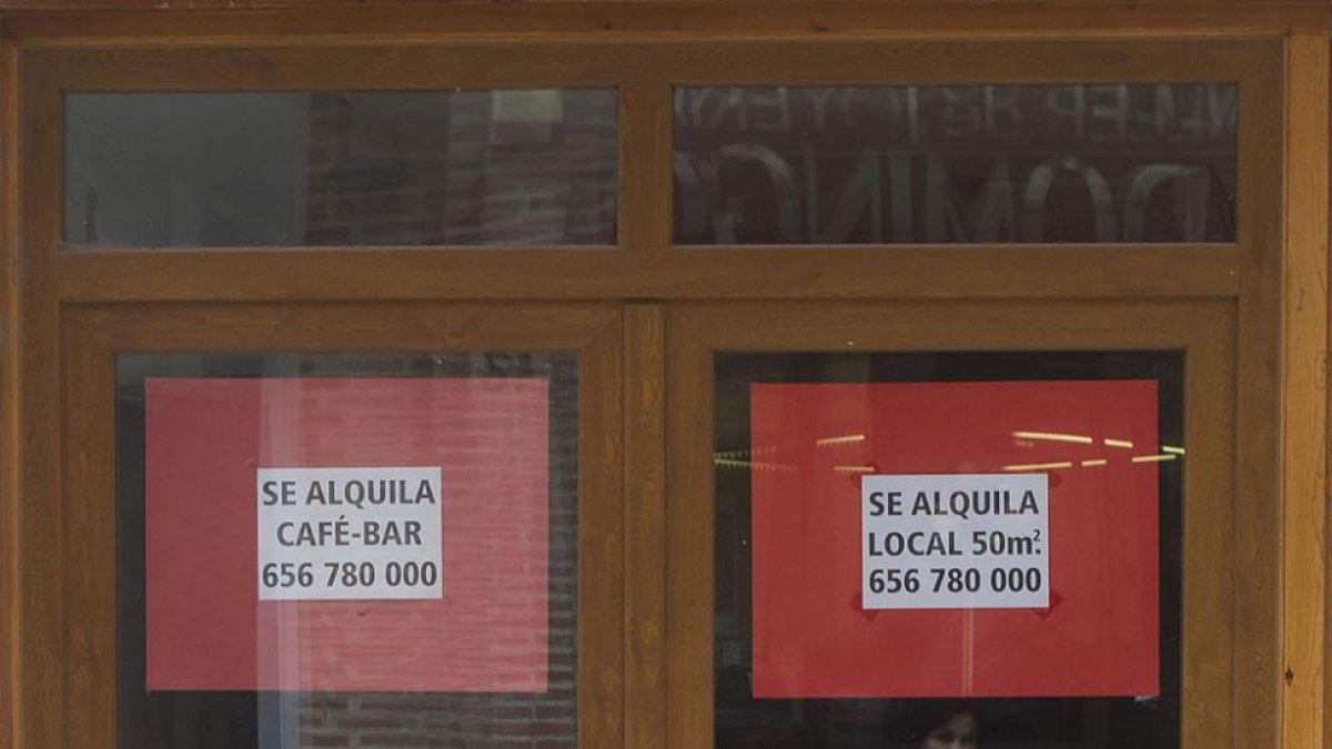 Una mujer pasa frente al escaparate de un local en alquiler.-ISRAEL L. MURILLO
