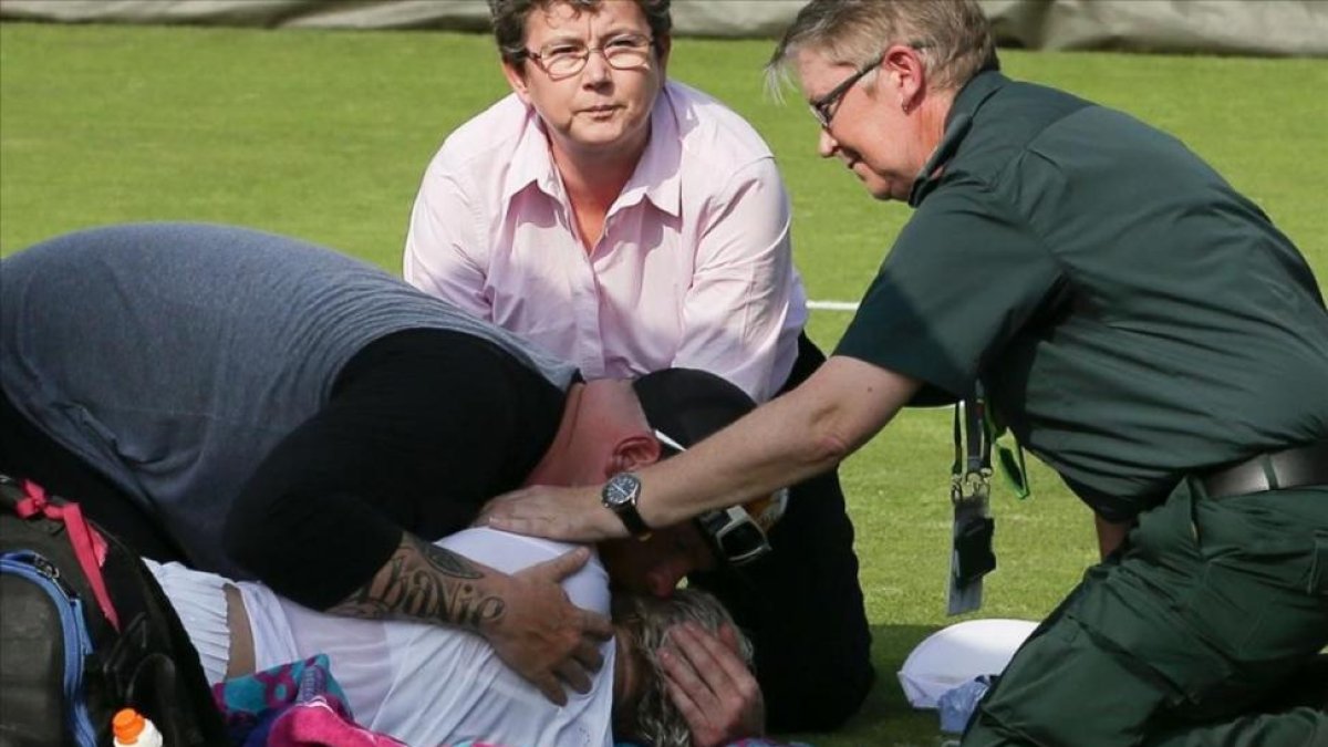 Bethanie Mattek-Sands, atendida por los servicios médicos tras la grave lesión de rodilla.-AFP / DANIEL LEAL-OLIVAS