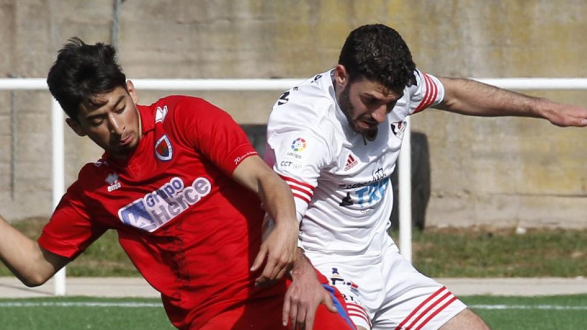 Sergio pelea un balón con un zaguero del Numancia B-Santi Otero