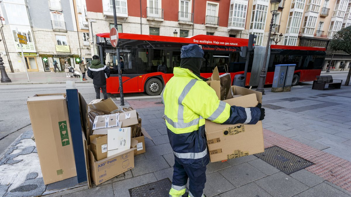 Un operario de Urbaser recoge cartones de la vía pública en una calle de Burgos.