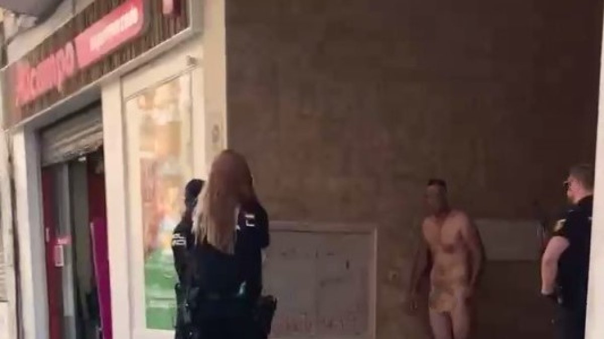 Los agentes de Policía Nacional rodean al individuo que se desnudó en la avenida de Castilla, junto al Alcampo.