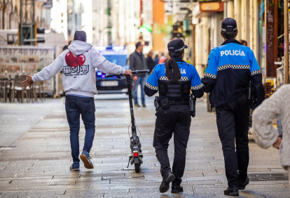 Control policial en una calle peatonal del centro de Burgos a los conductores de patinetes eléctricos.