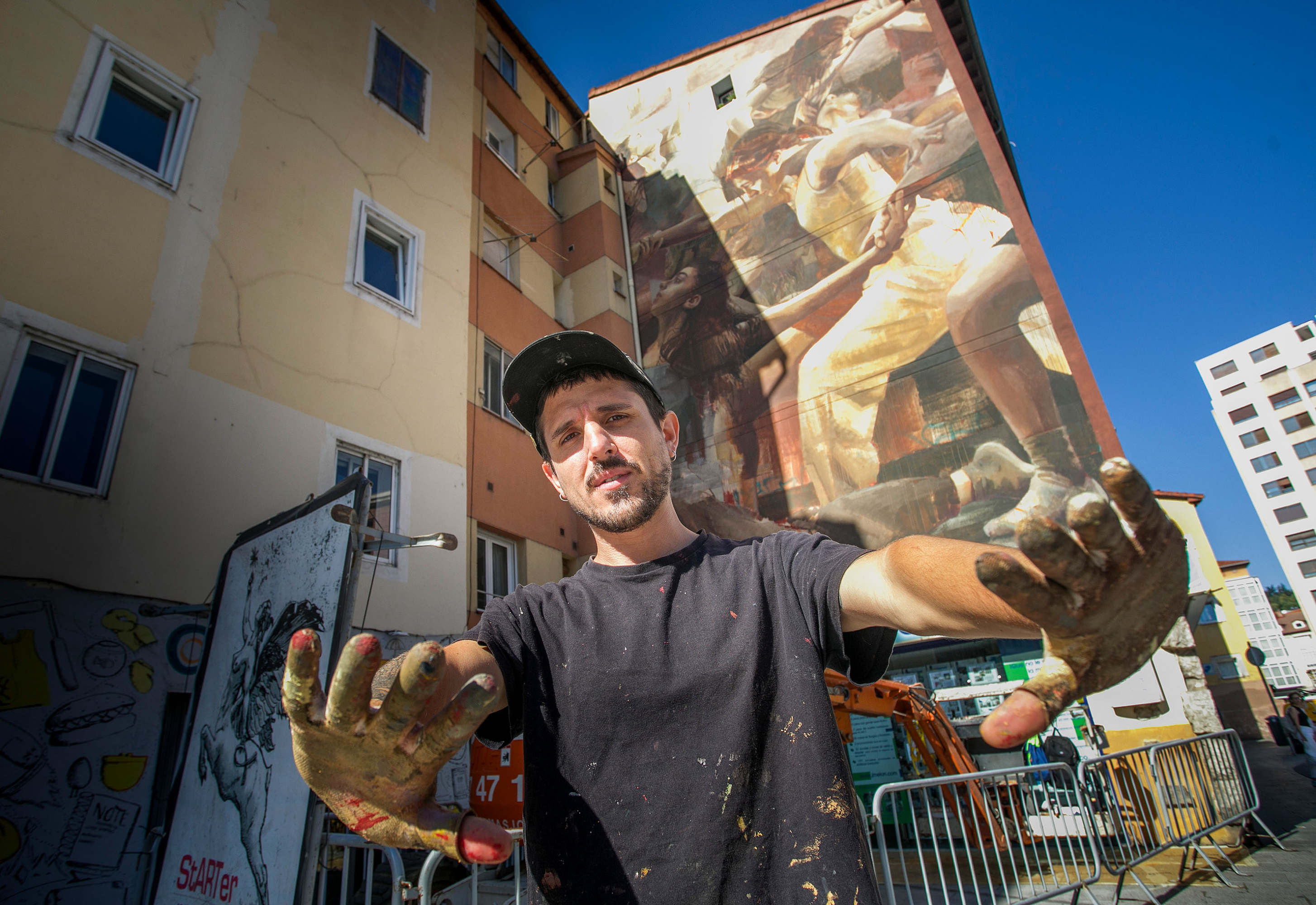 Guido Palmadessa posa justo delante de la nueva obra de arte urbano que se puede visitar en Burgos, en la plaza Hortelanos.